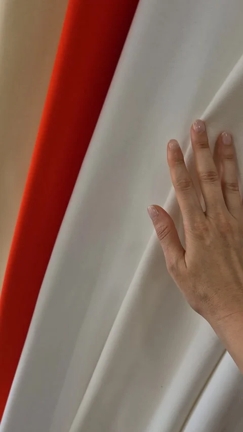 A person evaluates fabric by touch, selecting from a variety of colors Stock Footage 311857862
