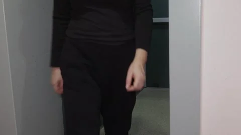 Person exiting elevator indoors, everyday movement 스톡 동영상 329184583