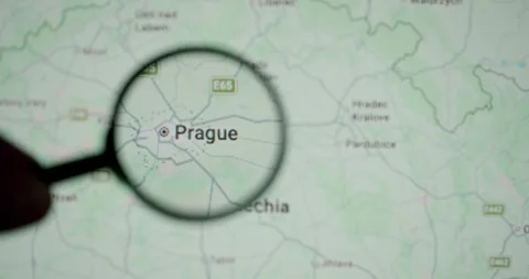 Person exploring the city of Prague on a digital map with a magnifying glass Stock Footage 345588321