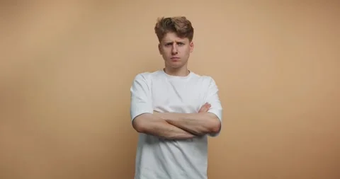 Person expresses different emotions in front of a plain background during a.. 스톡 동영상 328247056