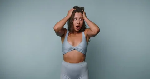 Person expresses surprise while striking a pose in a light blue outfit agai.. Vidéo 326788573