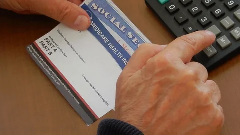 Person figuring retirement plans with social programs Stock Footage 108683083