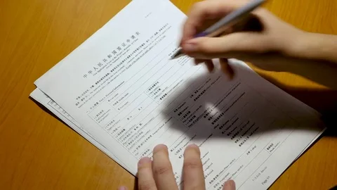 The person fills in the documents and the questionnaire. visa to China Stock Footage 84993653
