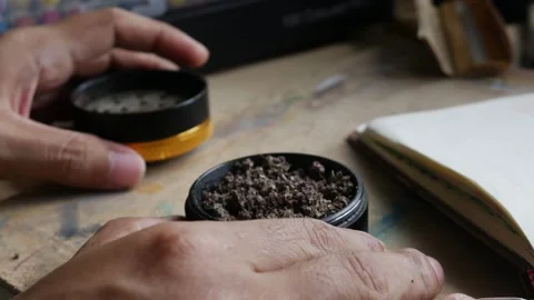Person Finger Testing Texture of Crushed Dry Marijuana. Stock Footage 324902712