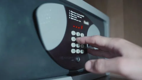 Person with flashlight trying to open safe box or vault but fails with code Stock Footage 284392258