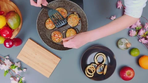 Person flipping stuffed fried snacks in kitchen from overhead view Stock Footage 342936360