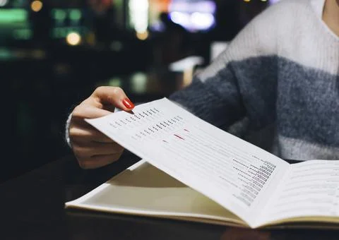 Person flipping through a menu Stock Photos