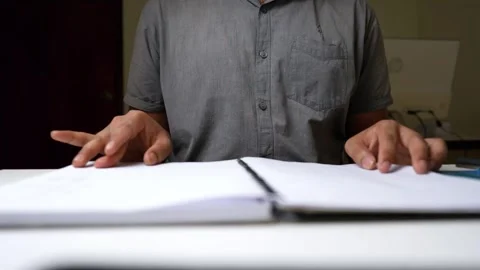 Person Flipping Through Notebook at Desk Stock Footage 320725034