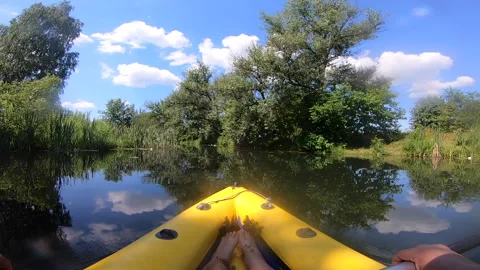 Person floating inflatable boat surface calm river thickets green grass reeds Stock Footage 280905147