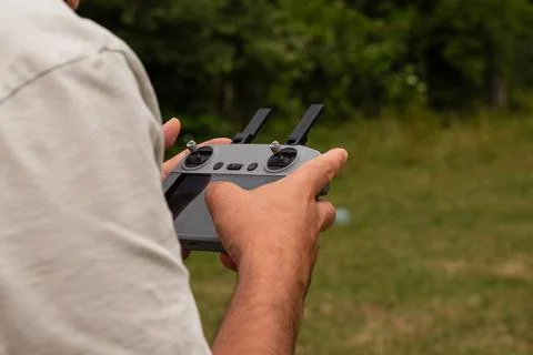 Person flying drone with remote control outdoors Photos
