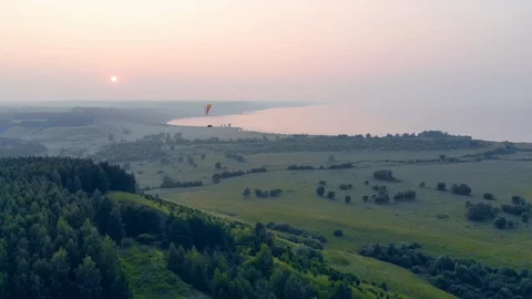 A person flying on a paraglide high above fields. Vídeo Stock 115203653