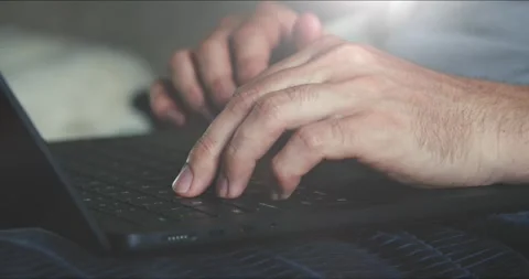 Person is focused on their laptop, typing, likely working or communicating 库存影片 277690973