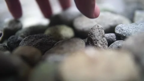 A person gently touches a rock with their hand, exploring its texture and natura Video stock 301582453