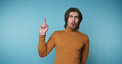 Person gestures with hand while explaining different points in a blue backg.. Видео 328249986