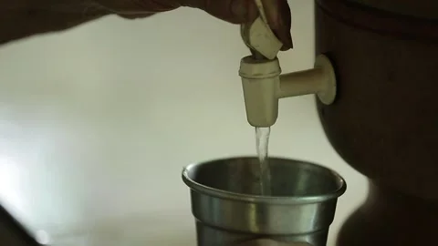 Person getting water from a clay filter, Natividade, Tocantins Stock Footage 317790160