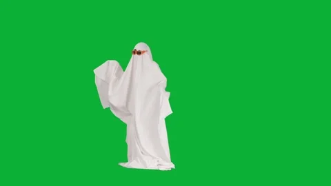 Person in ghost costume floating and waving arms on green screen background Stock Footage 313578462