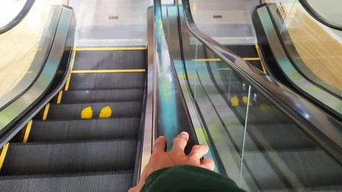 A person going down an escalator Stock-Fotos
