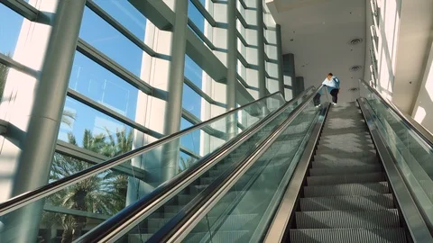 Person going up escalator inside Anaheim Convention Center Stock Footage 105682785