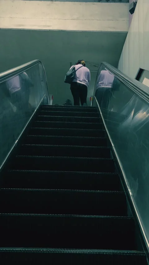 Person going up escalator in subway captured from above 스톡 동영상 333891507