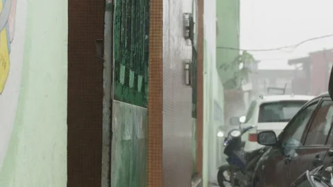 Person going inside to get out of torrential rain Stock Footage 318084157