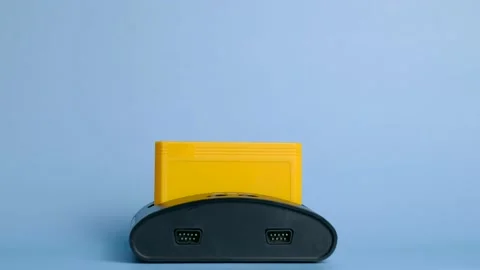 Person is going to play on an old game console. Stock Footage 165533697