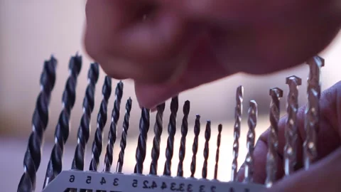 Person grab metal drill bit from sorted storage box, close up view, workshop Stock Footage 345293576