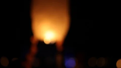 A person grabbing and letting go of a lantern sending it off into the night sky. Stock Footage