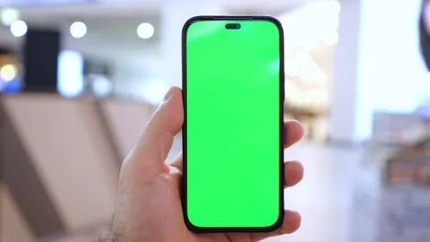 Person grips device with green display Stock Footage 345865340