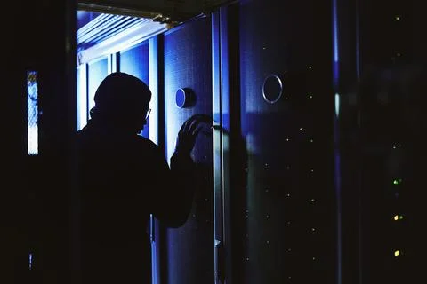 Person, hacker and mainframe in server room at night for cyberattack, data .. Stock Photos