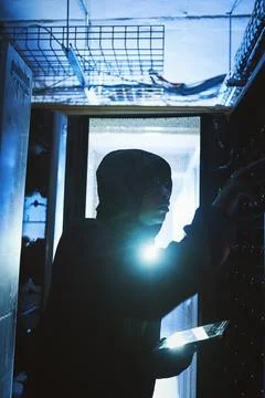 Person, hacker and tablet in data center at night for coding, cyber attack .. Foto stock