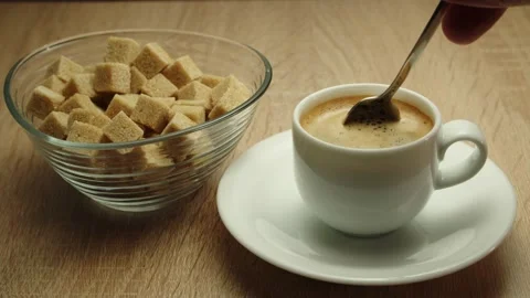 Person hand adding sugar and stirring coffee espresso Video stock 183892421