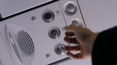 Person Hand up to adjust console panel at the air conditioner in airplane Stock Footage