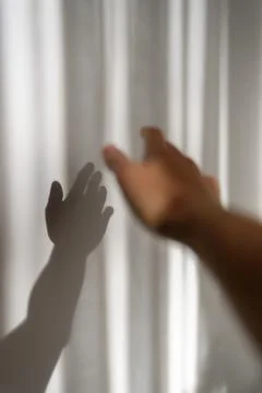 Person hand with its shadow on wall Stock Photos