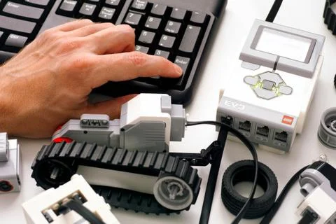 Person hand on keyboard coding LEGO MINDSTORMS EV3 robot blocks on computer. 写真素材