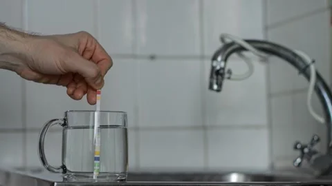 Person hand performing analysis of tap water quality at home, using simple test Stock Footage 329214078