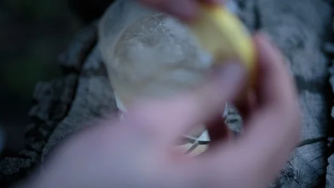 Person hand placing lemon slice on juice glass Stock Footage 94883645