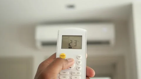 Person hand pressing remote control button to increase air conditioner temp.. Stock Footage 332777438