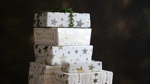 Person hand pushing over the stack of Christmas presents. Video stock 147345673