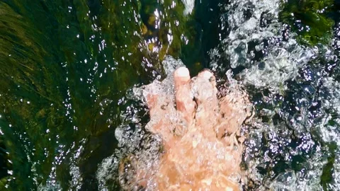 Person hand put in the flowing river and is captivated by the water Stock-Footage 199191579