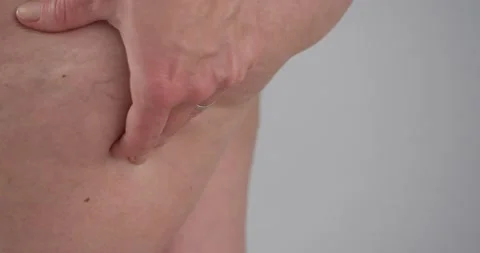 Person hand squeeze fat butt cheek and feeling unhappy with overweight Stock Footage 196788618