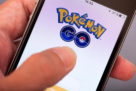 Person hand starting Pokemon Go application on apple iPhone5s Stock Photos