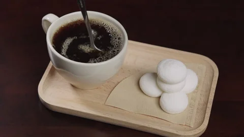 Person hand steering coffee in a cup with spoon. Breakfast morning of a cup.. Stock Footage 322554050