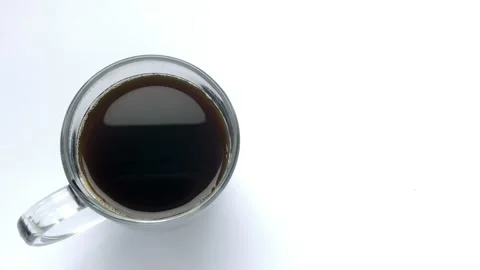Person hand stirring coffee a cup with spoon. Breakfast morning of a cup coffee Stock Footage 131745189
