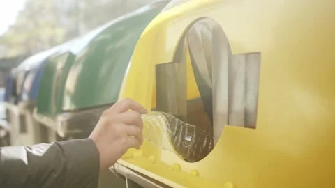 Person hand throwing plastic empty bottle in recycling bin, concept of ecology Stock Footage 168919689