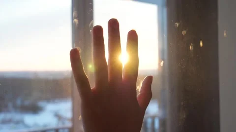 Person hand touching window during sunset dreaming about future Video stock 333622409