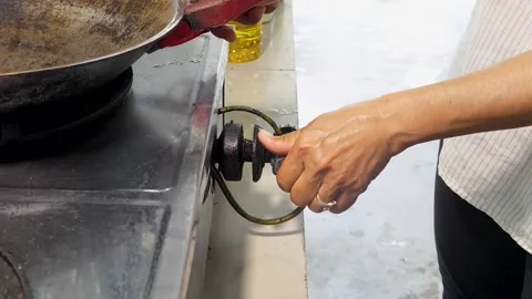 Person hand turns on kitchen Old Gas Knob on the Stove - cooking Stock Footage 147366354