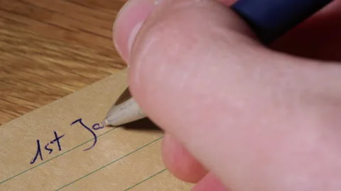 Person hand write future date of 2058 on paper notebook, close up view Stock Footage 235664420