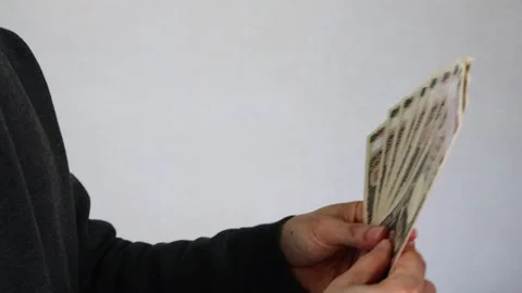 A person handing over a large amount of 10,000 yen bills Stock Footage 324545825