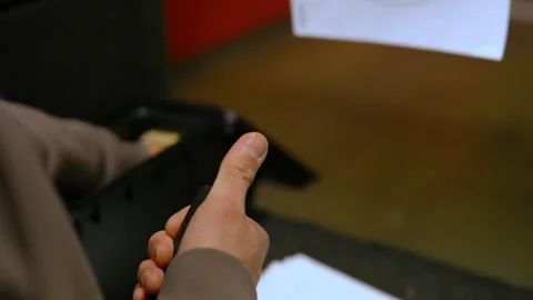 Person handling ammunition and loading a firearm magazine. Focus on hands Stockbeeldmateriaal 332185056