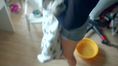 A person is handling a decorative blanket while a cat is nearby them Vidéo 318926843